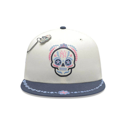 Pictured is this MLB Day Of The Dead New York Yankees 59FIFTY Fitted cap in light beige & dark blue. 2
