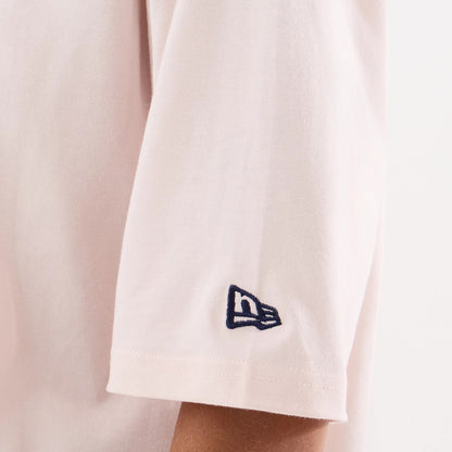 The model is wearing this Womens MLB Graphic New York Yankees T-Shirt in pastel pink. 4