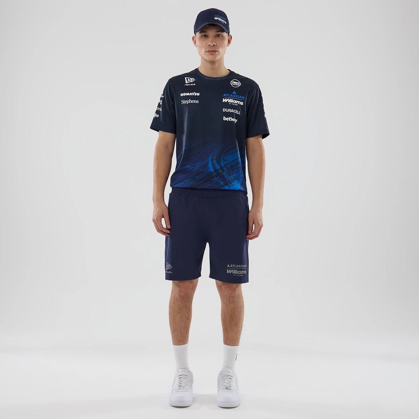The model is wearing these Atlassian Williams F1 Team Training Shorts in navy. 6