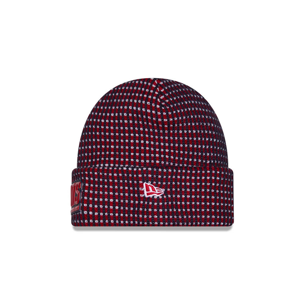 New Era New York Giants NFL Sideline 2026 Dark Blue Cuff Knit Beanie Hat, front view showing the red and dark blue speckled pattern, an embroidered white New Era flag logo on the cuff, and a partially Giants team logo label.