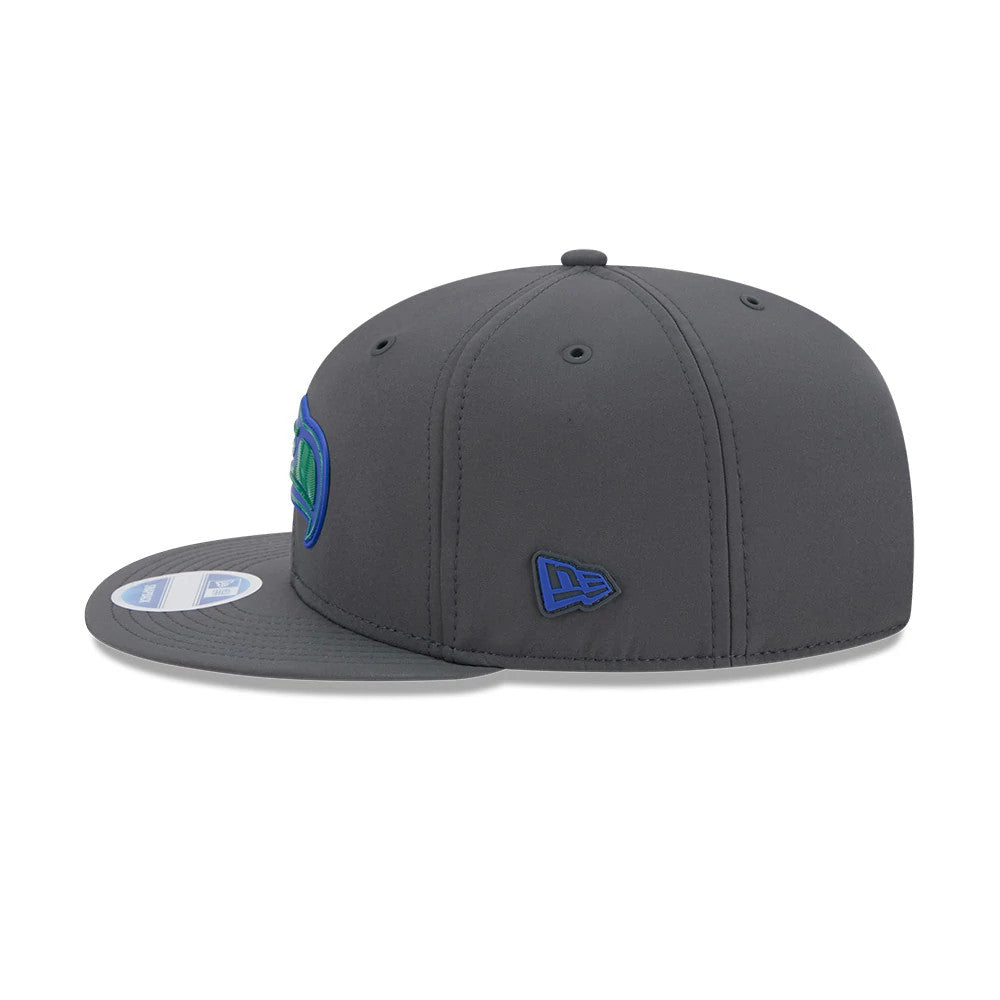 Seahawks NFL Sideline 2026 Charcoal New Era 9FIFTY Snapback Adjustable Cap, side view showing a blue embroidered New Era flag logo on the left side panel, a structured charcoal crown, and a coordinating flat charcoal visor.