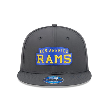 LA Rams NFL Sideline 2026 Charcoal New Era 9FIFTY Snapback Adjustable Cap, front view showing a blue and yellow Los Angeles Rams logo in raised embroidery on the charcoal front panel, with a 9FIFTY size sticker on the flat visor.