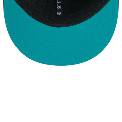 Miami Dolphins NFL Sideline 2026 Charcoal New Era 9FIFTY Snapback Adjustable Cap, inside view showing a teal undervisor, black taping with the 9FIFTY label, and a matching black sweatband for a clean finish.