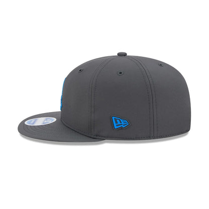 Detroit Lions NFL Sideline 2026 Charcoal New Era 9FIFTY Snapback Adjustable Cap, side view showing the blue embroidered New Era flag logo on the left side, flat charcoal visor with size sticker, and structured charcoal crown.
