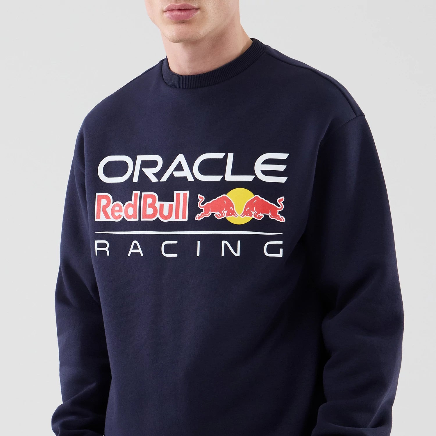The model is wearing this Red Bull Racing Oversized Crew Neck Sweater in dark blue. 3