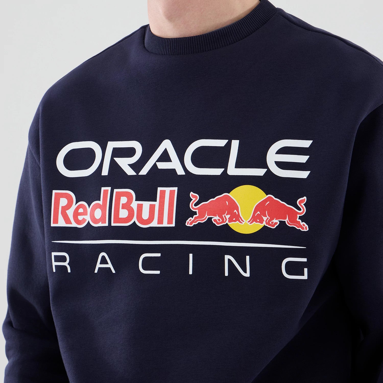 The model is wearing this Red Bull Racing Oversized Crew Neck Sweater in dark blue. 4