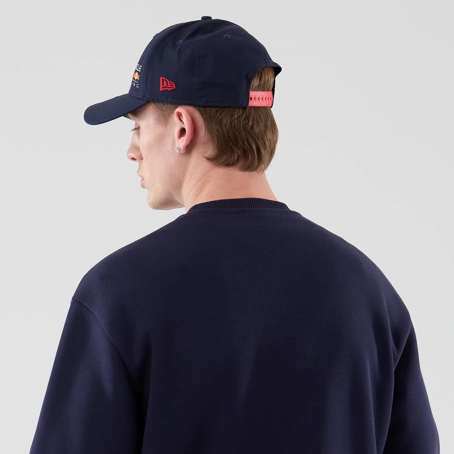 The model is wearing this Red Bull Racing Oversized Crew Neck Sweater in dark blue. 6