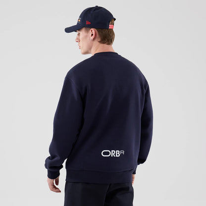 The model is wearing this Red Bull Racing Oversized Crew Neck Sweater in dark blue. 2