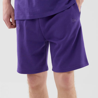 The model is wearing these NBA League Essential LA Lakers Oversized Shorts in purple. 3