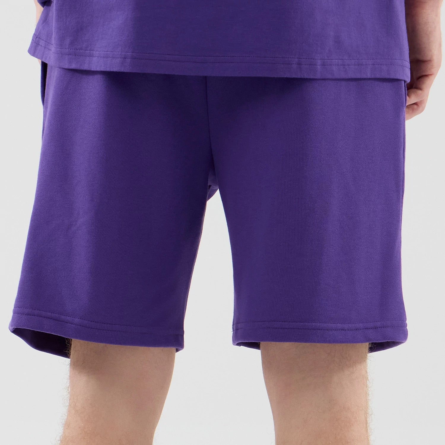 The model is wearing these NBA League Essential LA Lakers Oversized Shorts in purple. 7