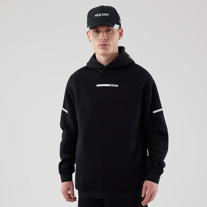 The model is wearing this New Era Tech Oversized Pullover Hoodie in black. 1