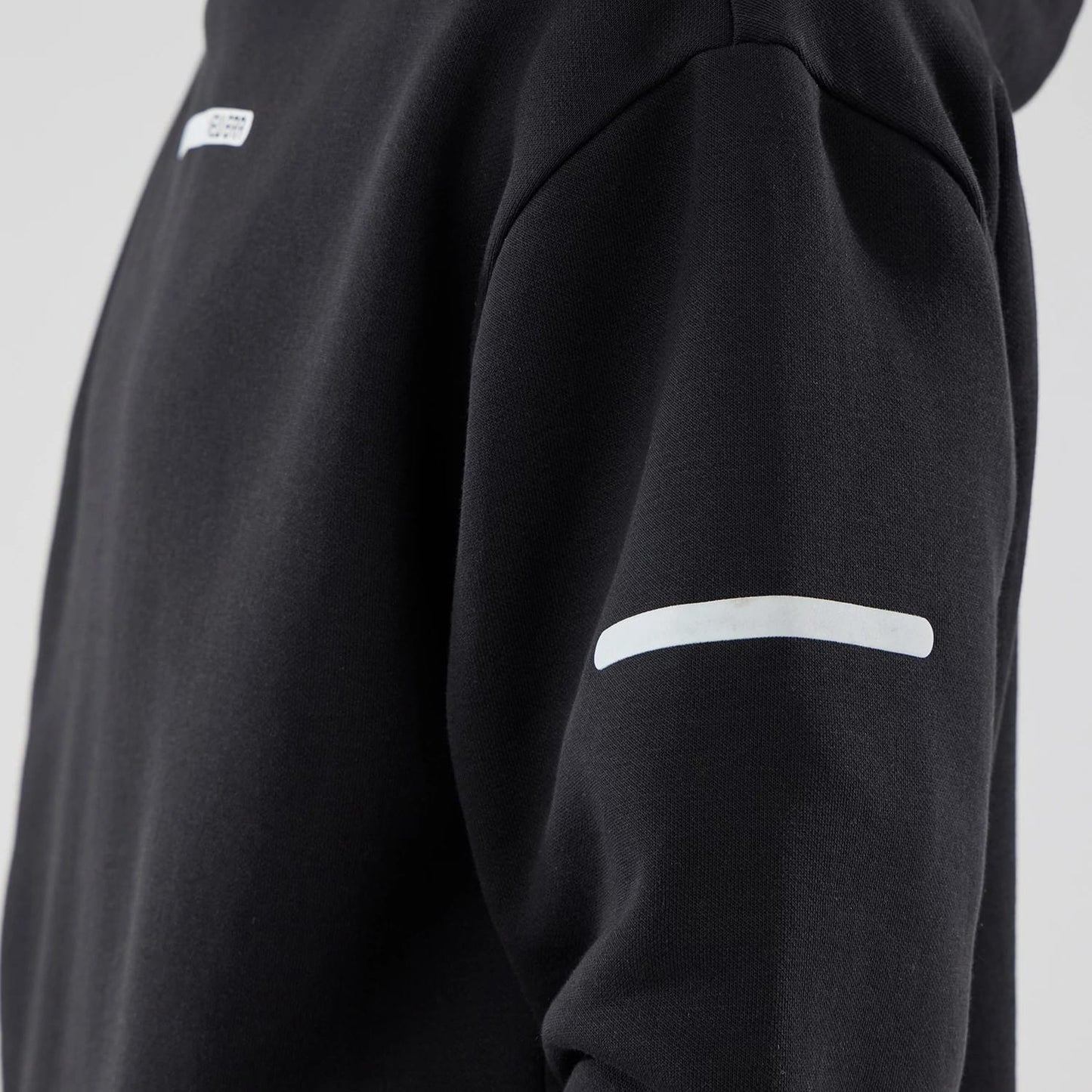 The model is wearing this New Era Tech Oversized Pullover Hoodie in black. 6