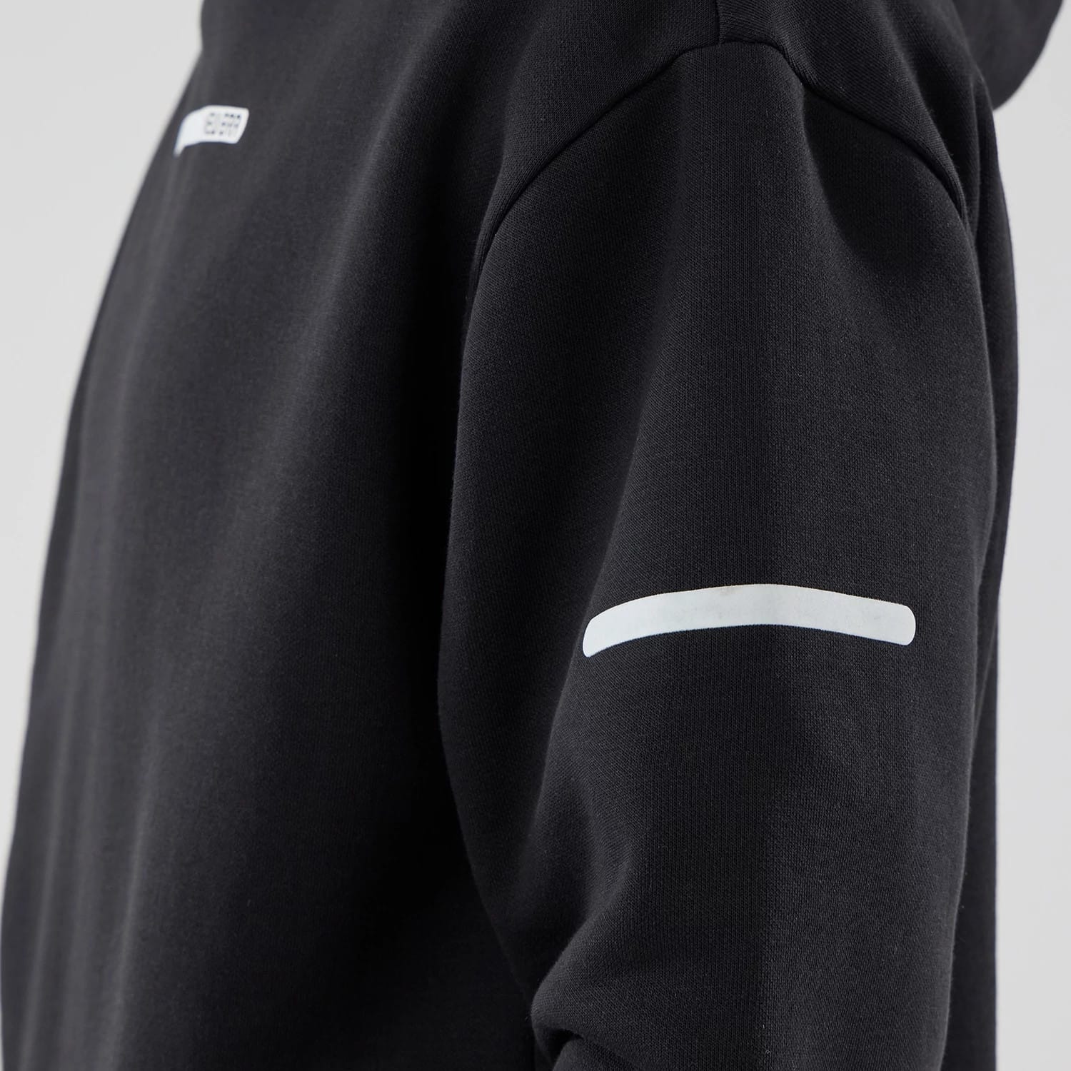 The model is wearing this New Era Tech Oversized Pullover Hoodie in black. 6