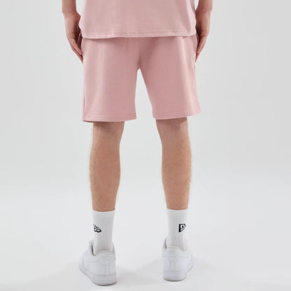 The model is wearing these MLB Midi League Essential LA Dodgers Oversized Shorts in pastel pink. 2