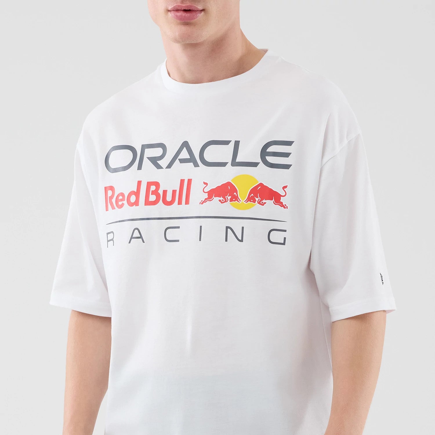 The model is wearing this Red Bull Racing Graphic Oversized T-Shirt in white. 3