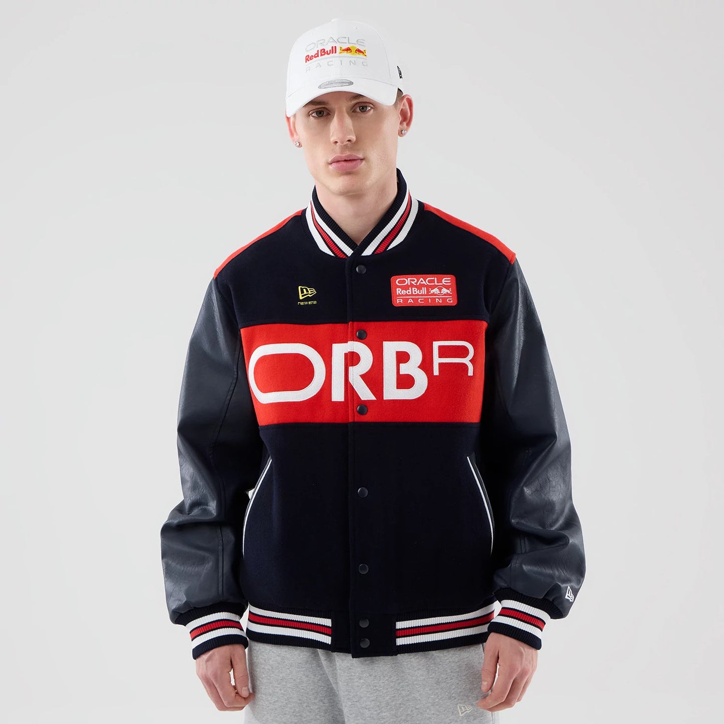 The model is wearing this Red Bull Racing wordmark Varsity Jacket in dark blue. 1
