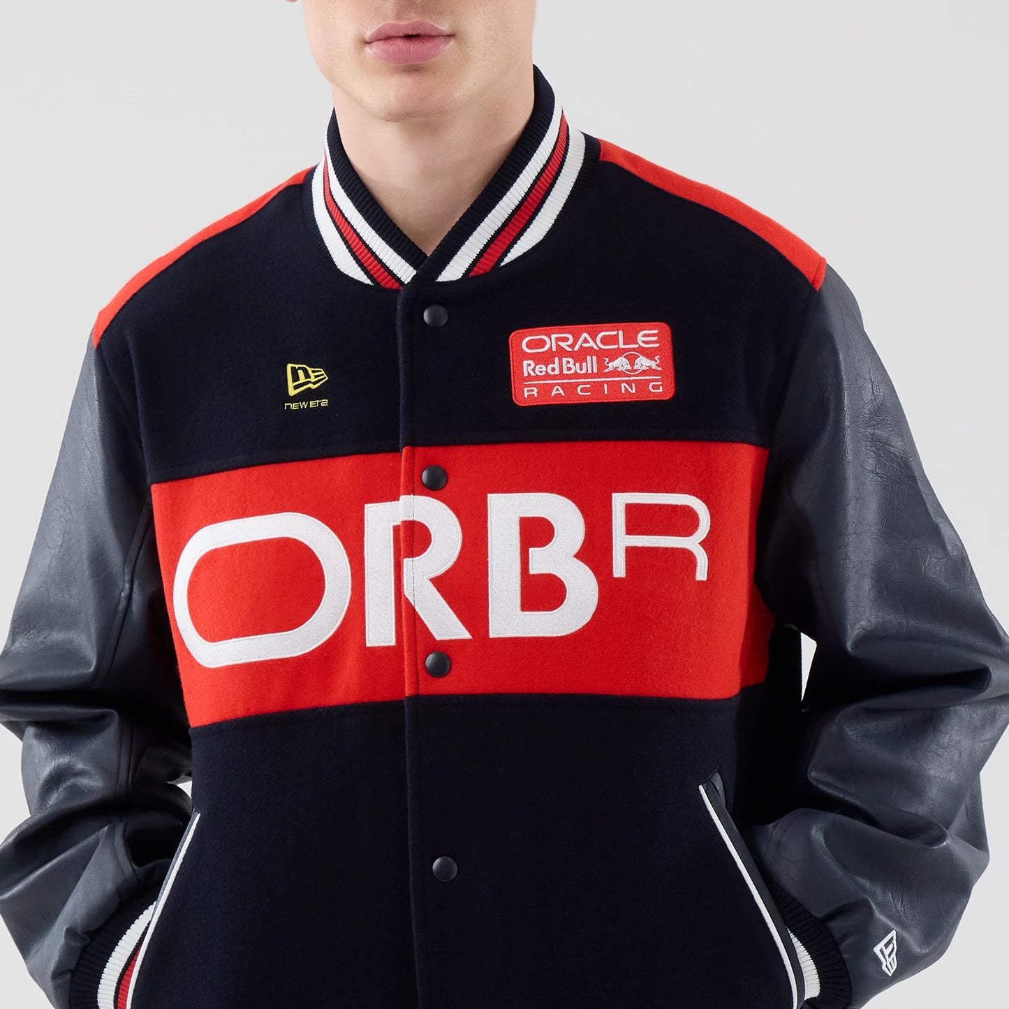 The model is wearing this Red Bull Racing wordmark Varsity Jacket in dark blue. 3