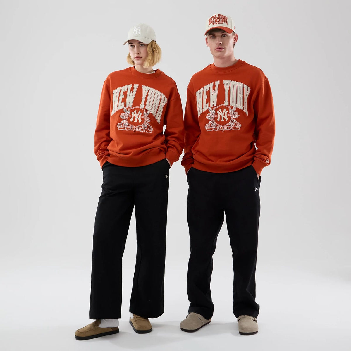 The model is wearing this MLB Arch Graphic New York Yankees Oversized Crew Neck Sweater in Orange. 1