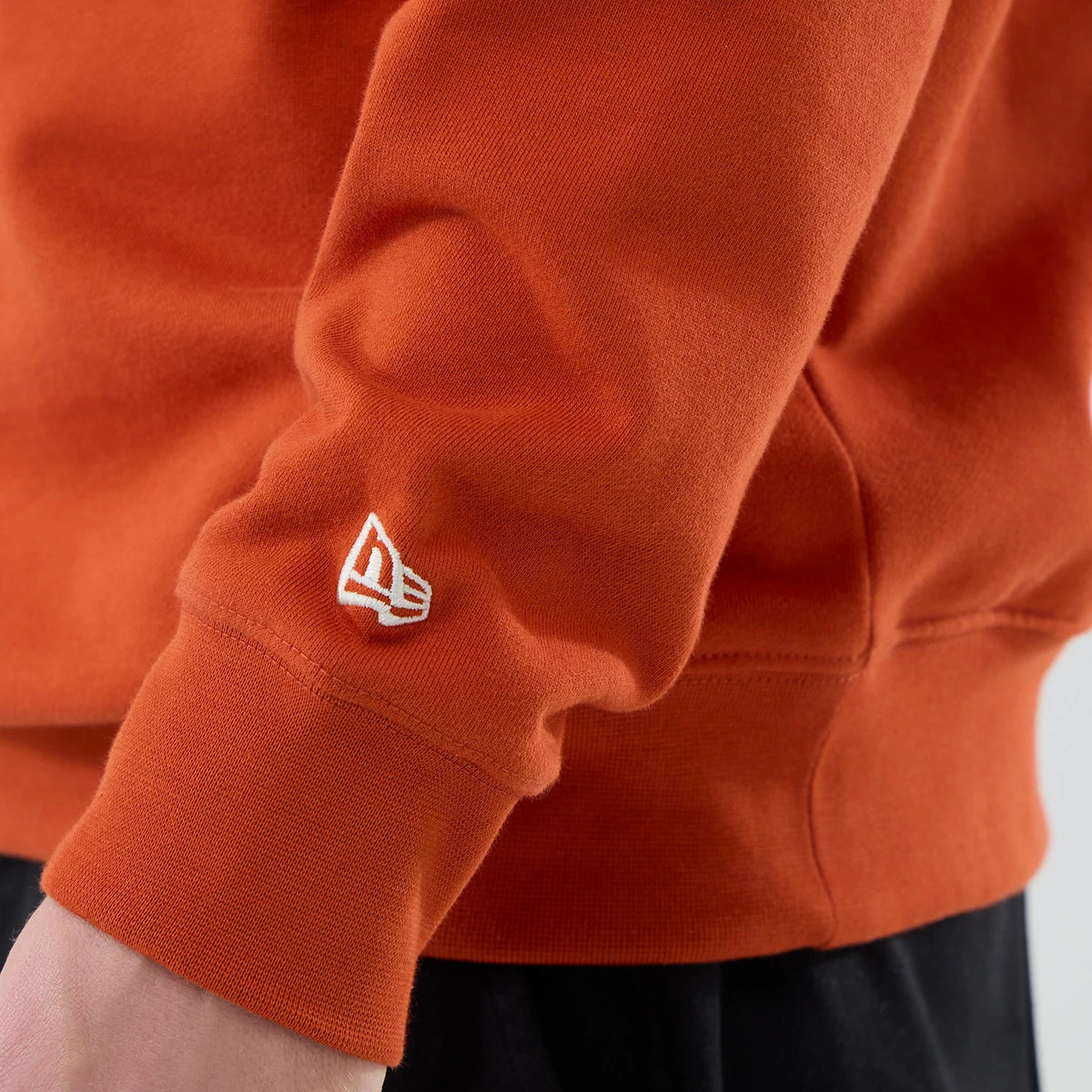 The model is wearing this MLB Arch Graphic New York Yankees Oversized Crew Neck Sweater in Orange. 7