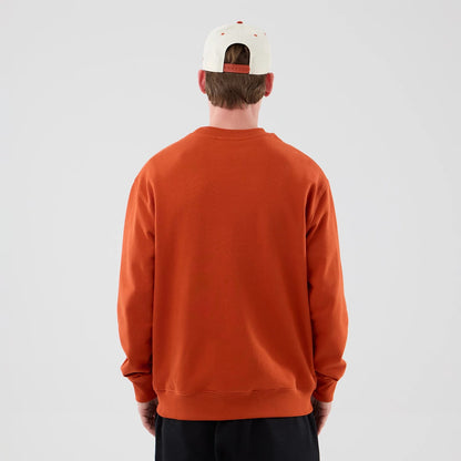 The model is wearing this MLB Arch Graphic New York Yankees Oversized Crew Neck Sweater in Orange. 2
