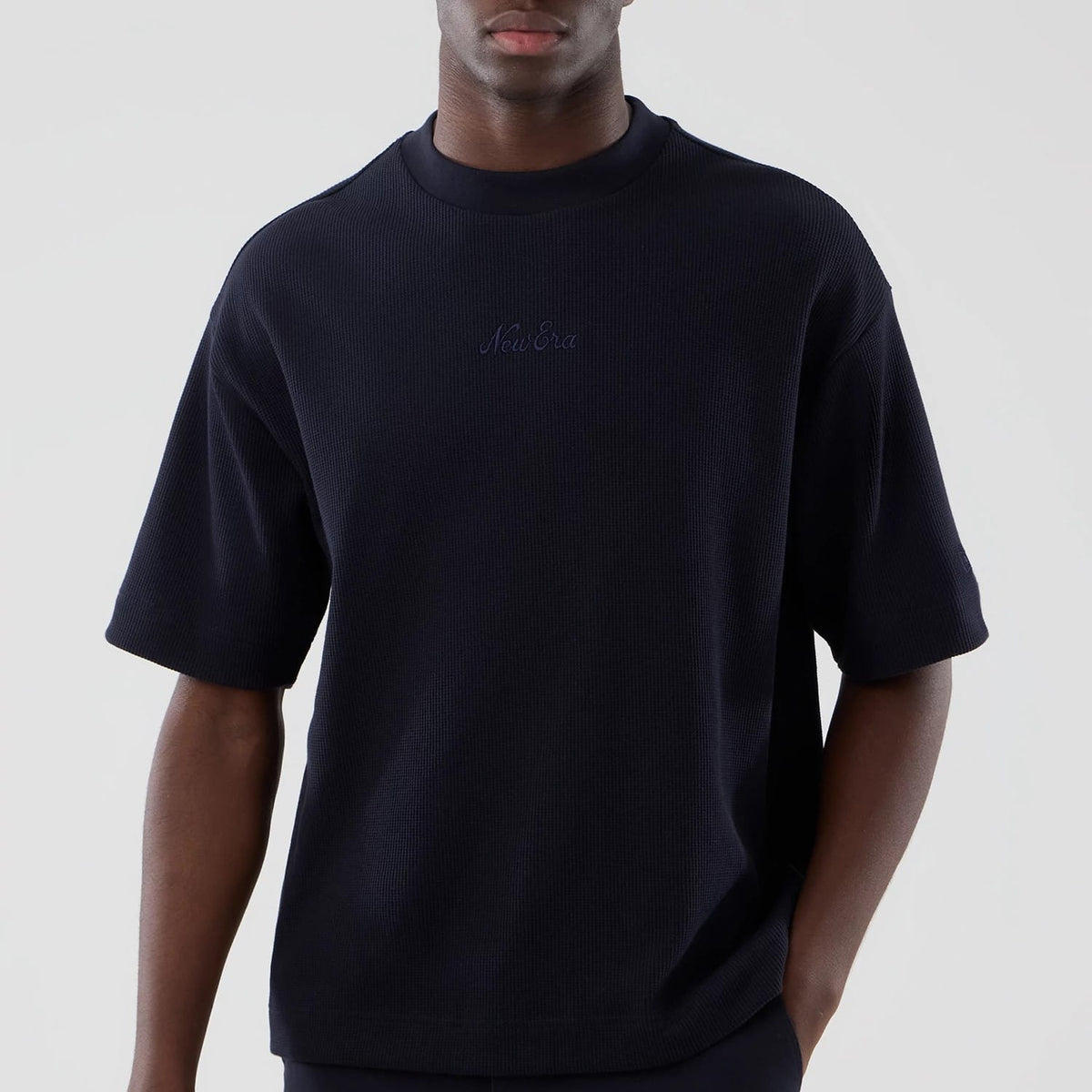 The model is wearing this New Era Waffle Boxy T-Shirt in navy. 3