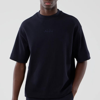 The model is wearing this New Era Waffle Boxy T-Shirt in navy. 3