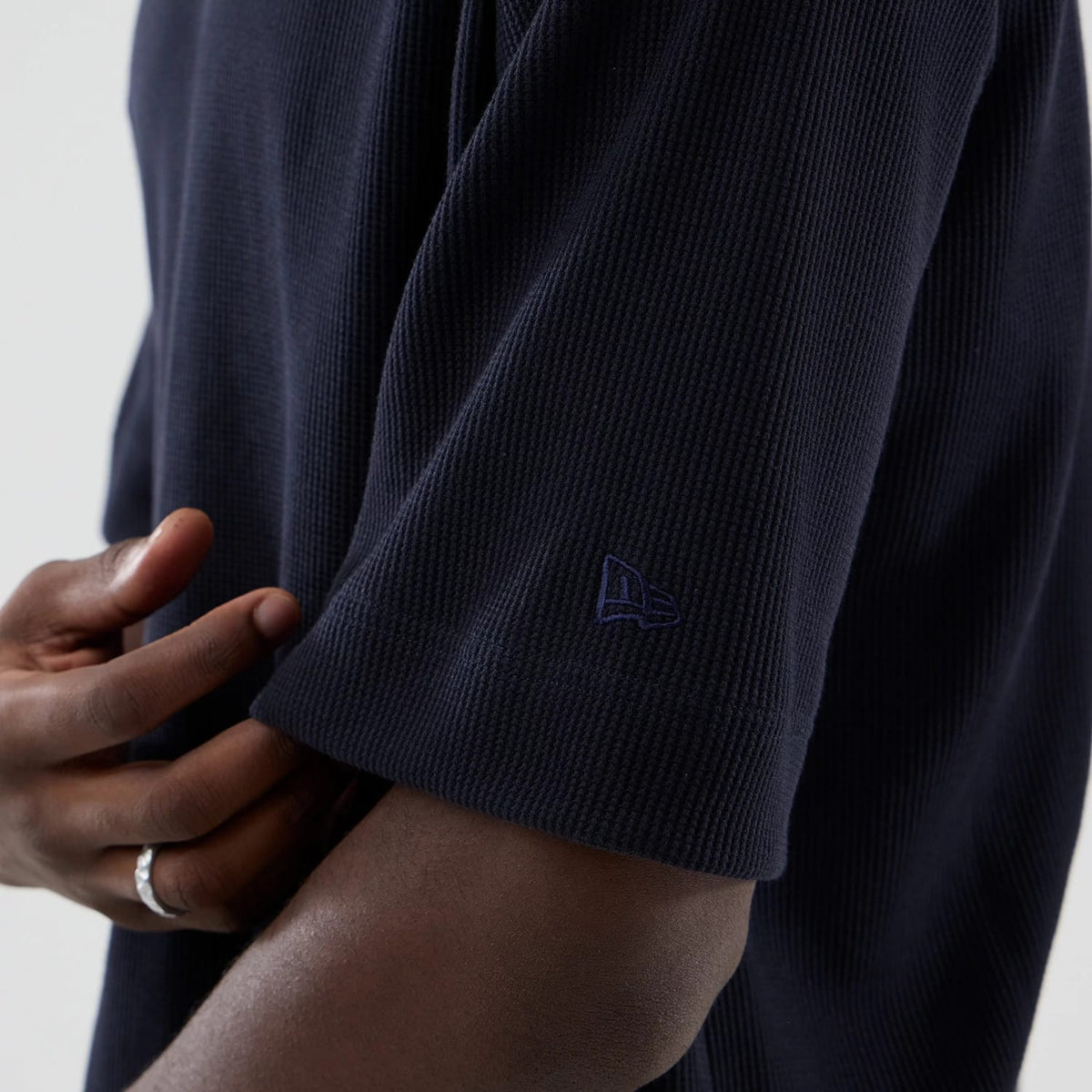 The model is wearing this New Era Waffle Boxy T-Shirt in navy. 5