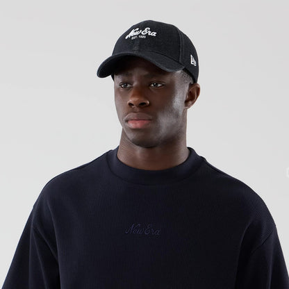 The model is wearing this New Era Waffle Boxy T-Shirt in navy. 6