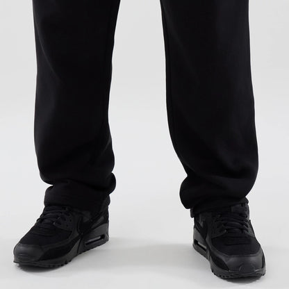 New Era Tech Reflective Black Straight Leg Joggers, close-up front view showing the lower legs with a relaxed fit and a black fabric, worn with black trainers for a and contemporary look.