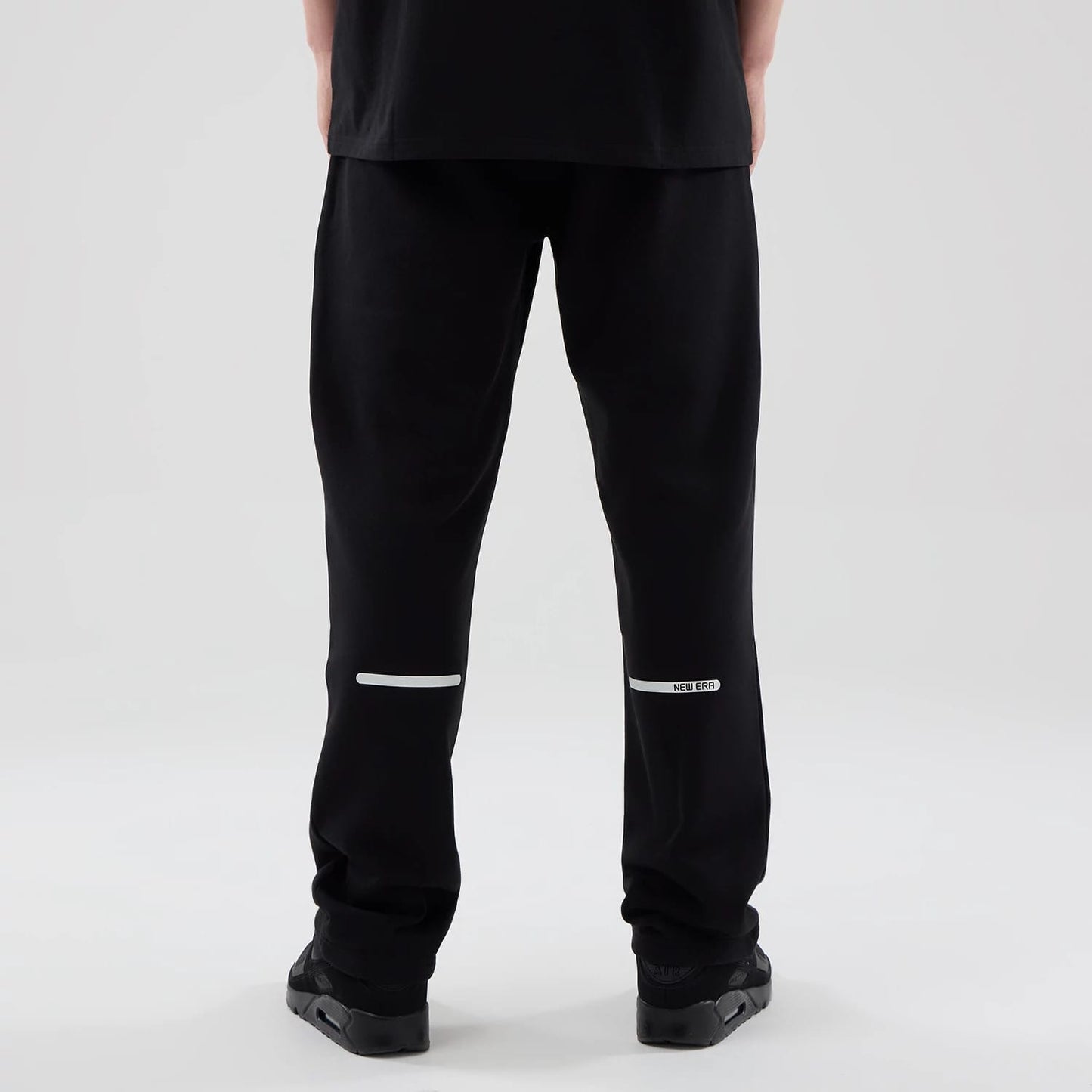 The model is wearing these New Era Tech Straight Leg Joggers in black. 2