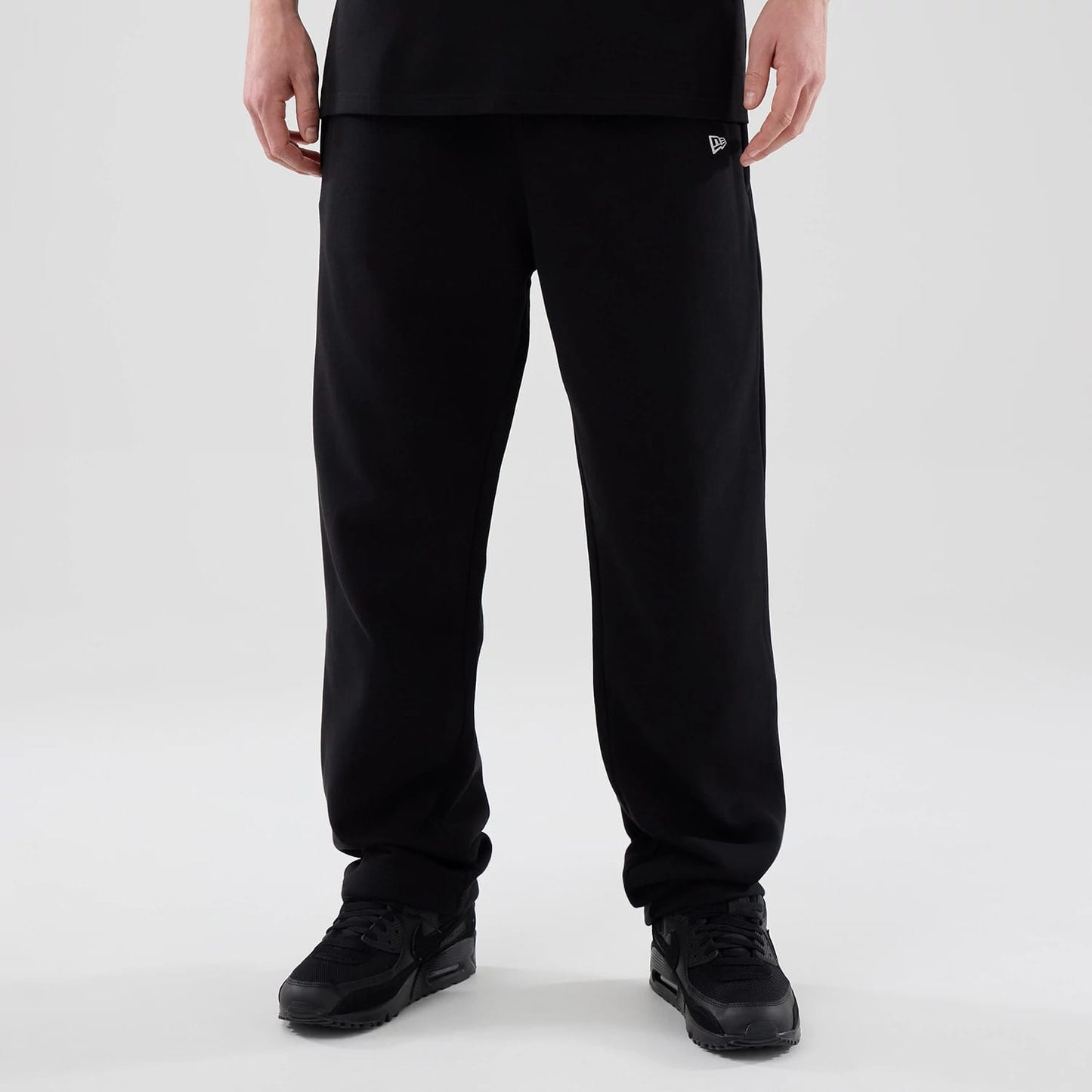 The model is wearing these New Era Tech Straight Leg Joggers in black. 1