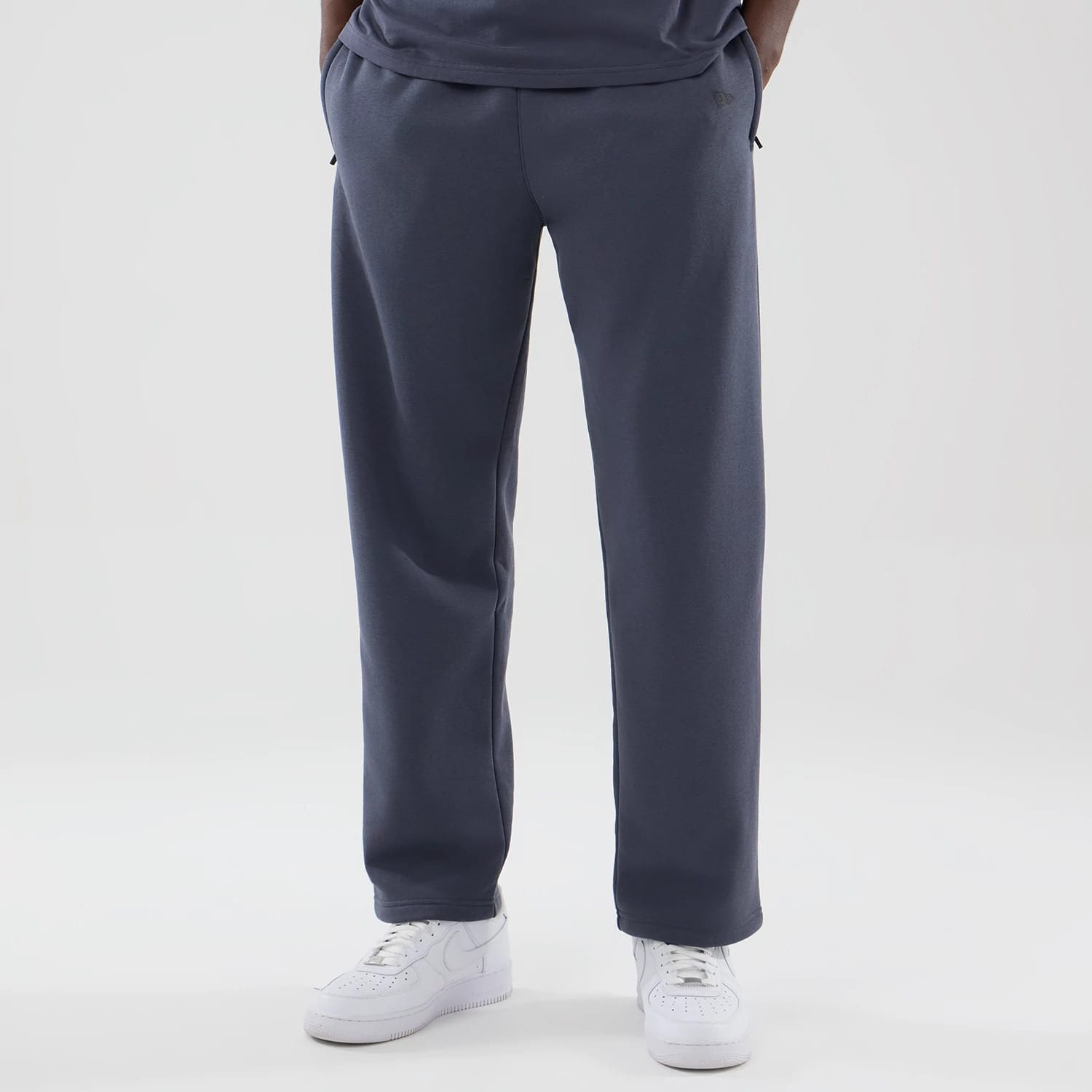 The model is wearing these New Era Tech Straight Leg Joggers in grey. 3