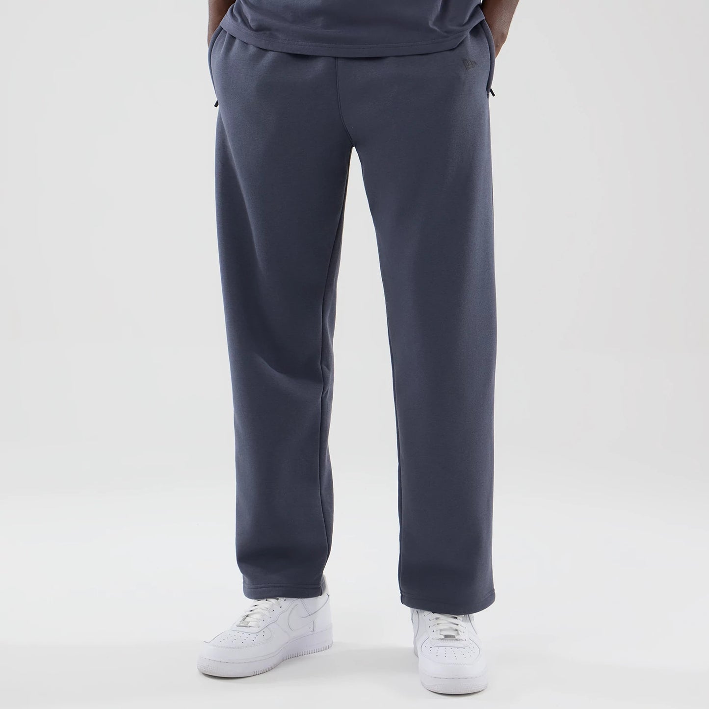 The model is wearing these New Era Tech Straight Leg Joggers in grey. 3