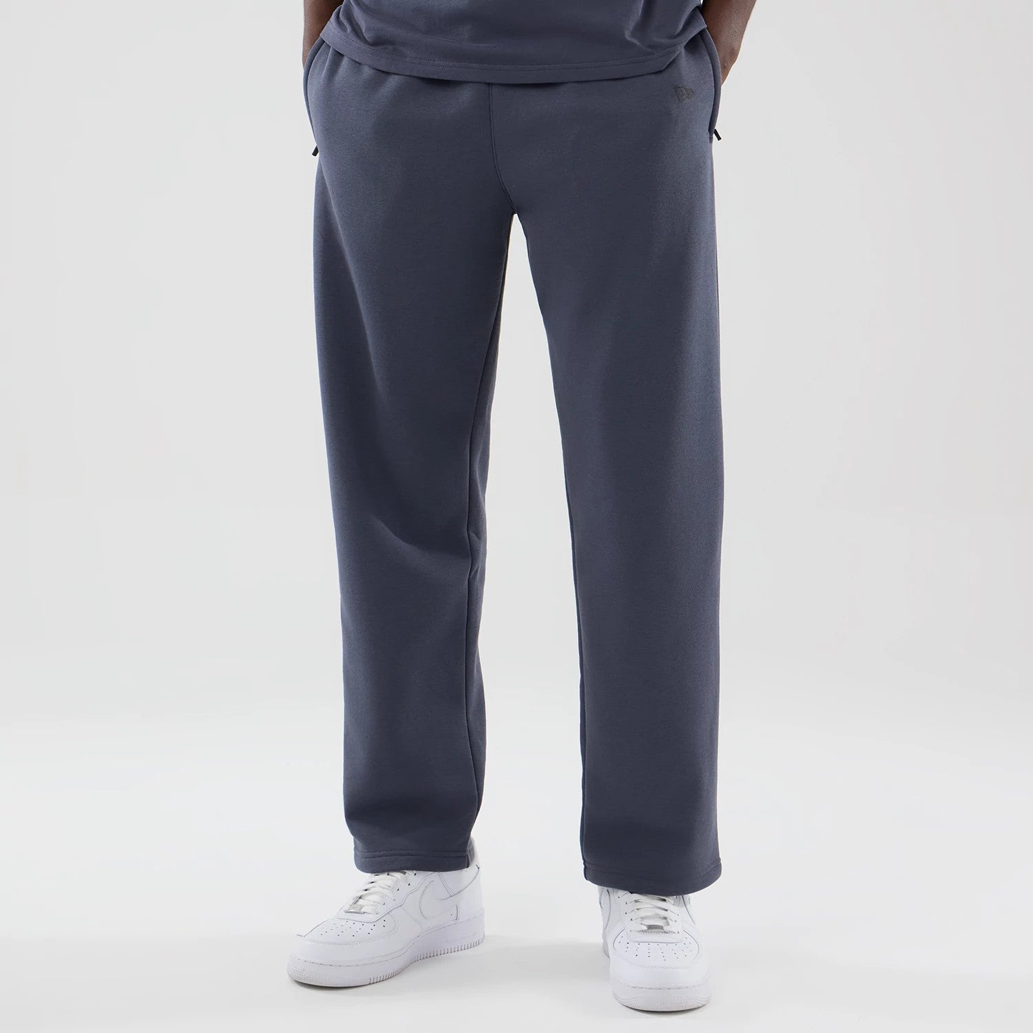 The model is wearing these New Era Tech Straight Leg Joggers in grey. 3