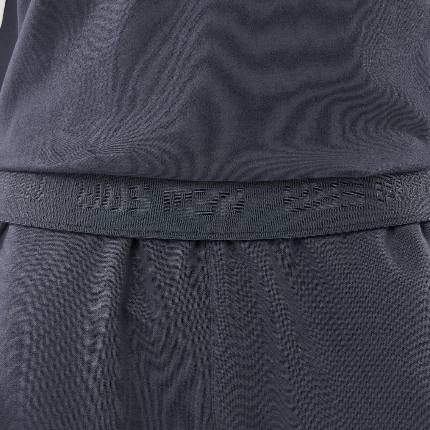 The model is wearing these New Era Tech Straight Leg Joggers in grey. 4