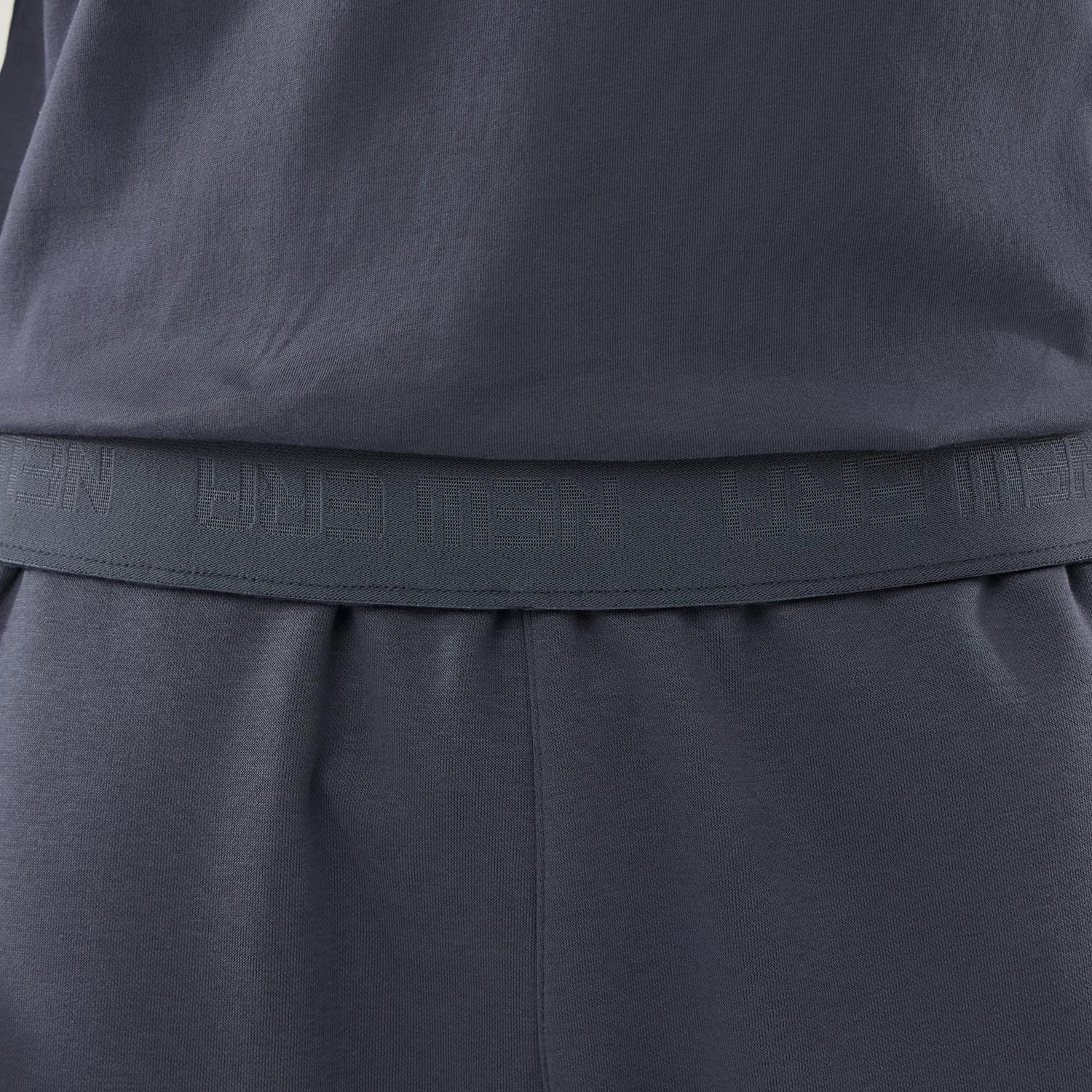 The model is wearing these New Era Tech Straight Leg Joggers in grey. 4