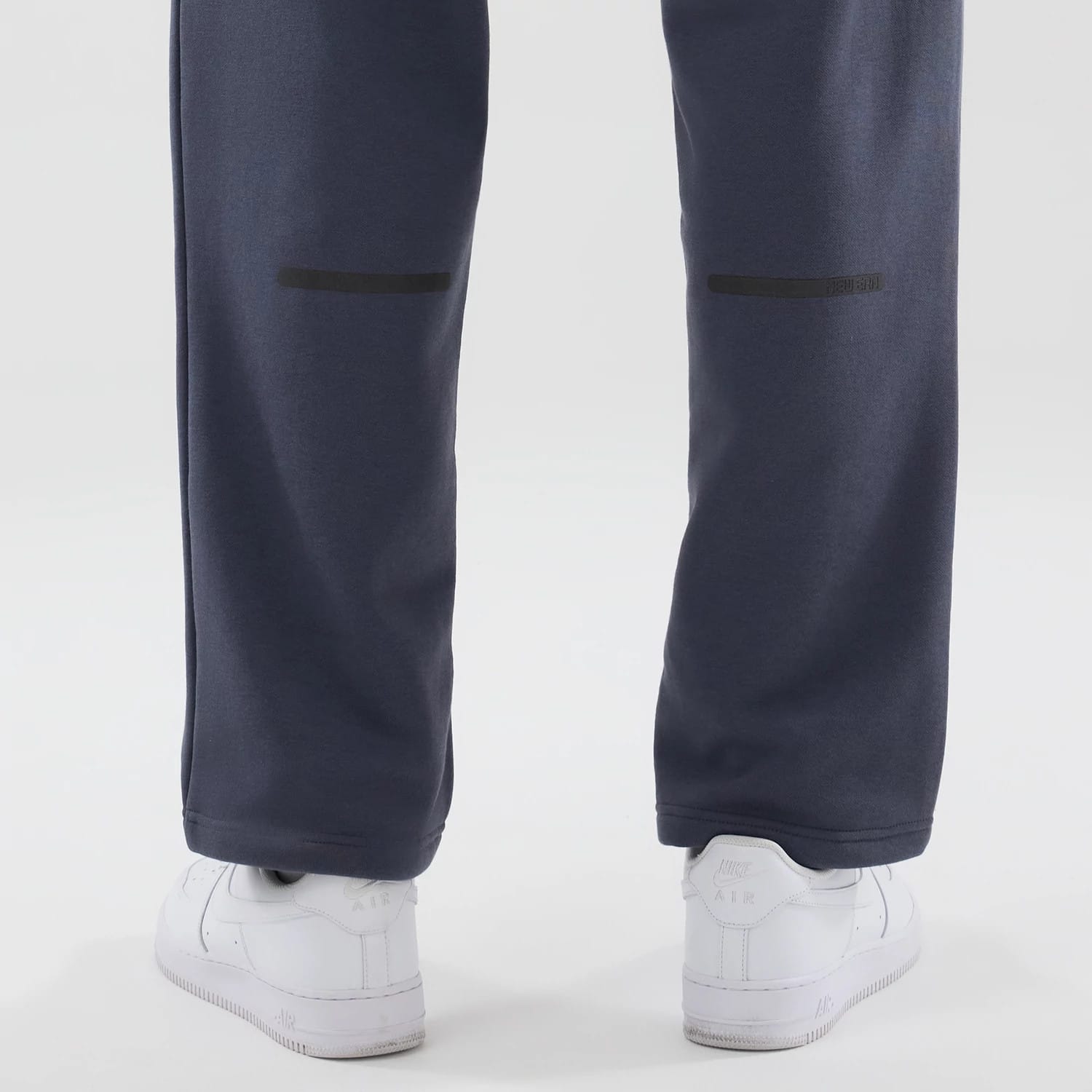 The model is wearing these New Era Tech Straight Leg Joggers in grey. 7