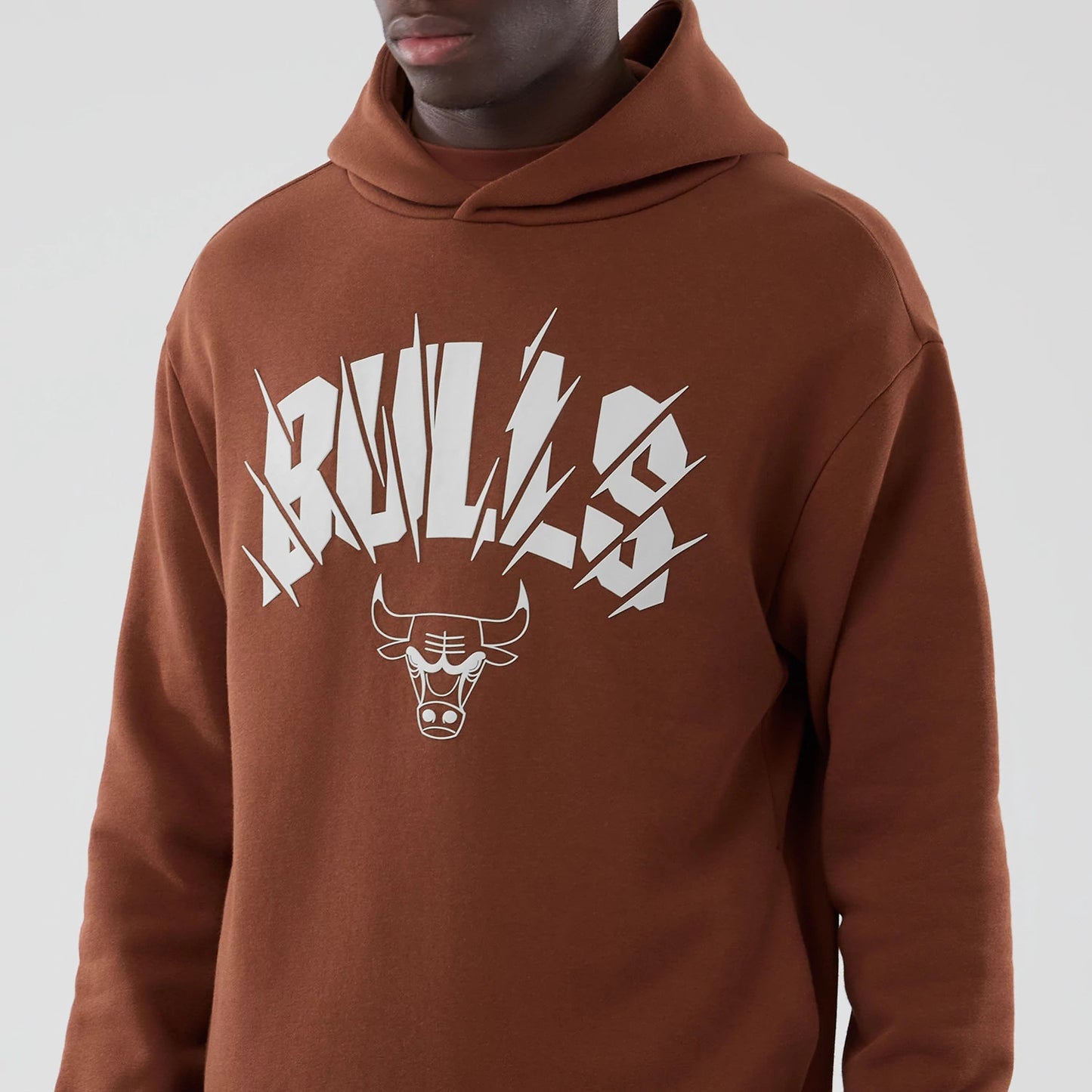 The model is wearing this NBA Core Plus Chicago Bulls Pullover Hoodie in brown. 5