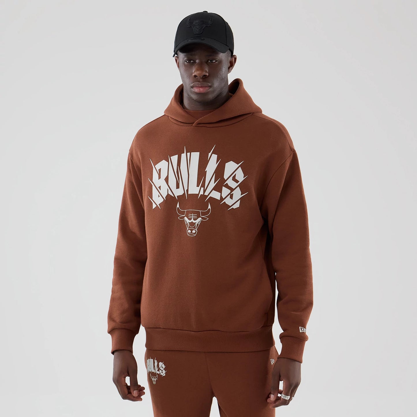 The model is wearing this NBA Core Plus Chicago Bulls Pullover Hoodie in brown. 1