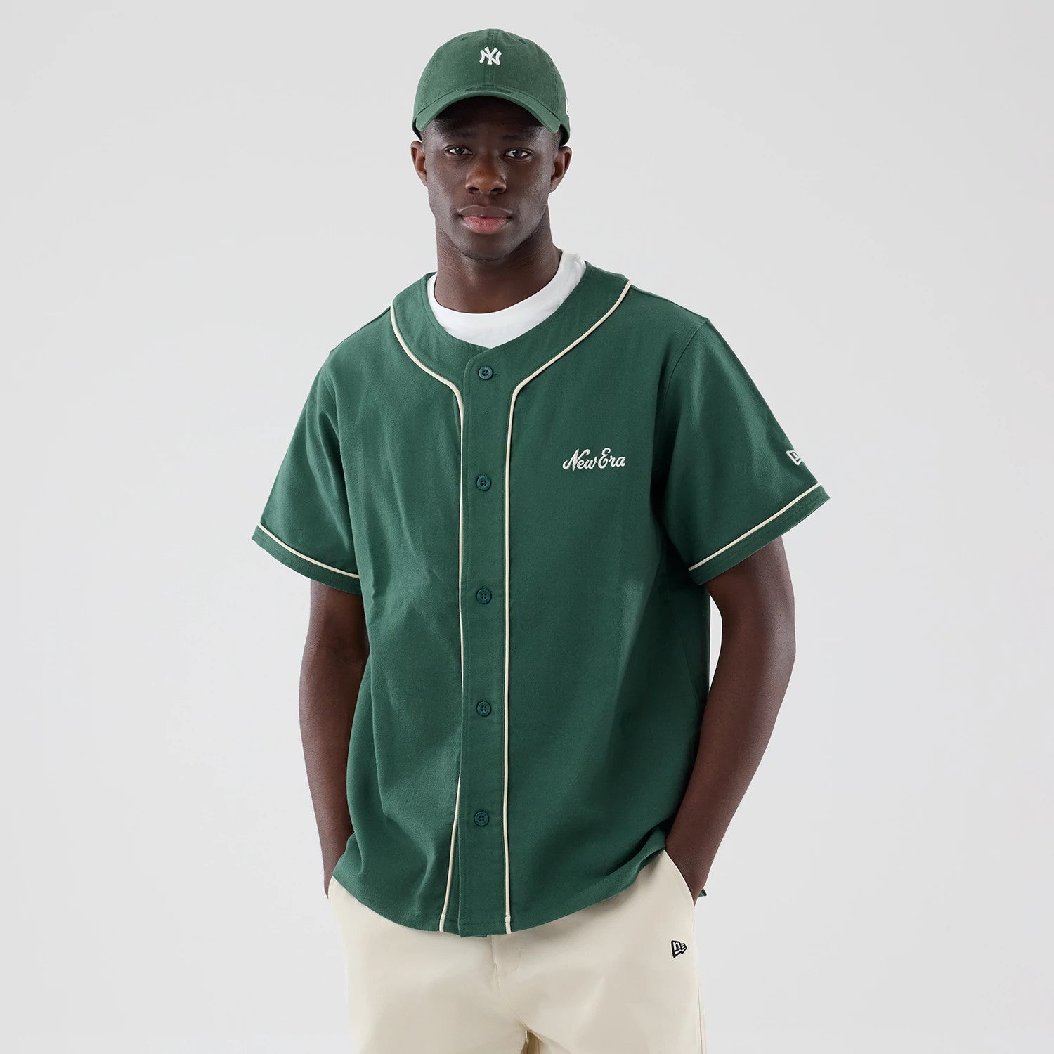 The model is wearing this New Era Baseball Jersey in dark green. 3