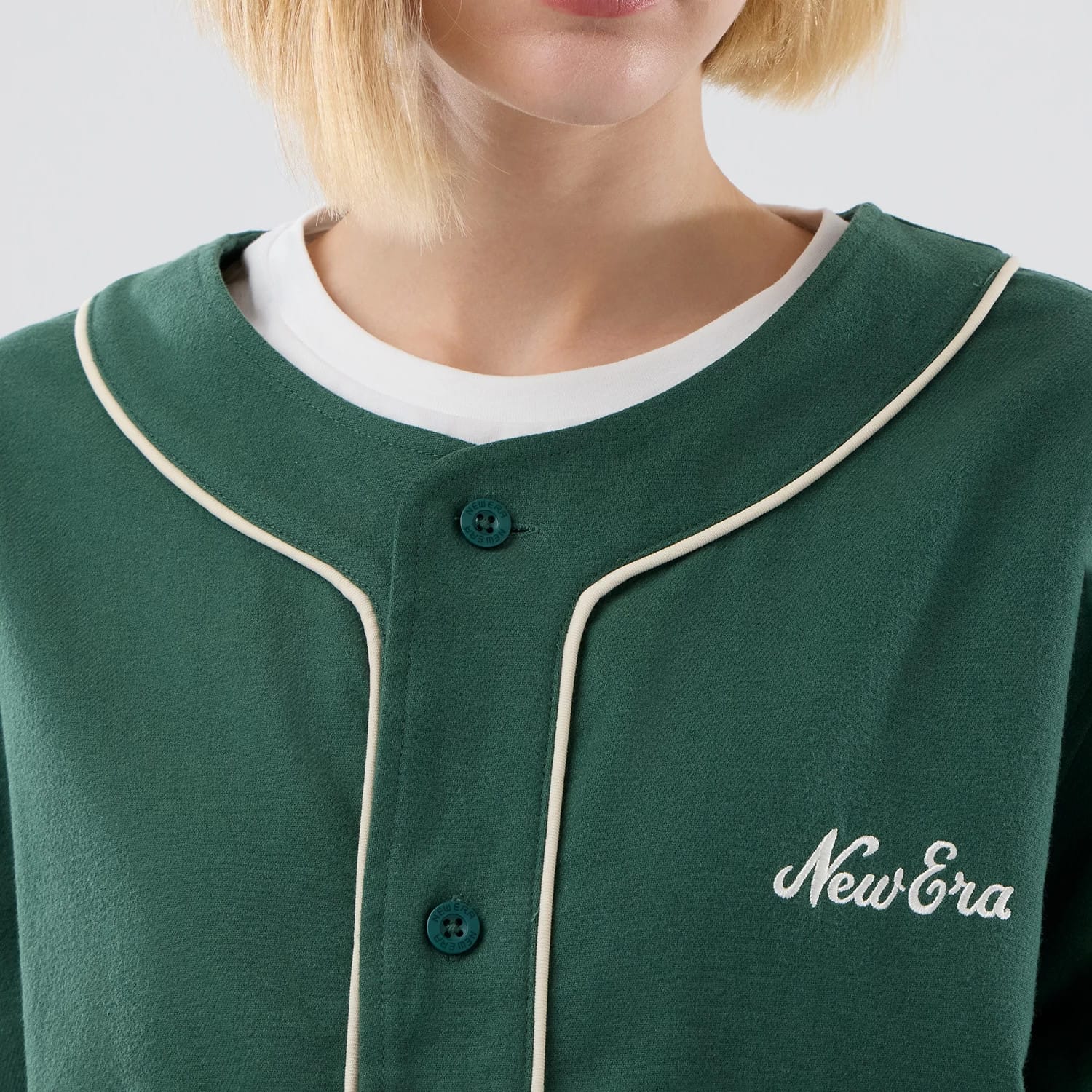 The model is wearing this New Era Baseball Jersey in dark green. 6