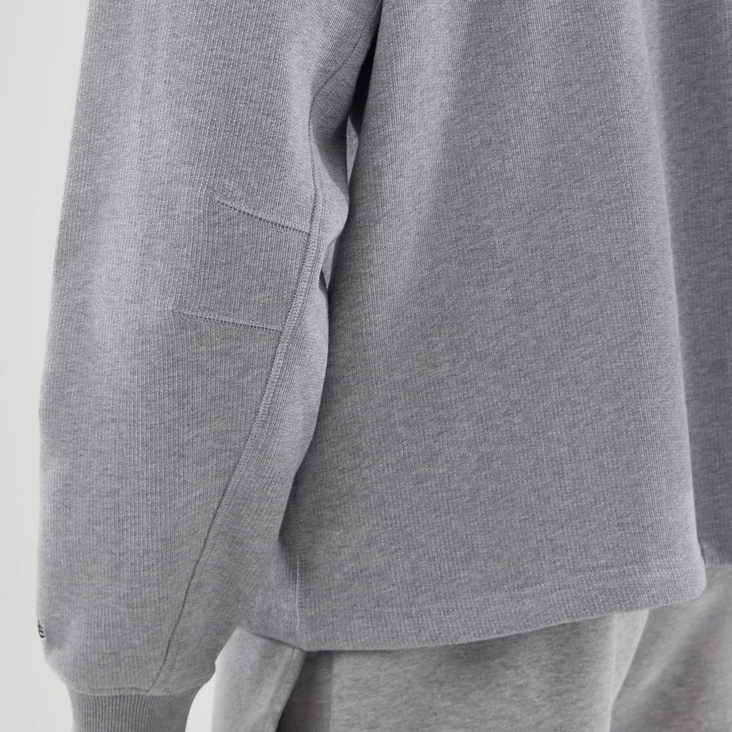 The model is wearing this New Era Oversized Crew Neck Sweater in grey. 6