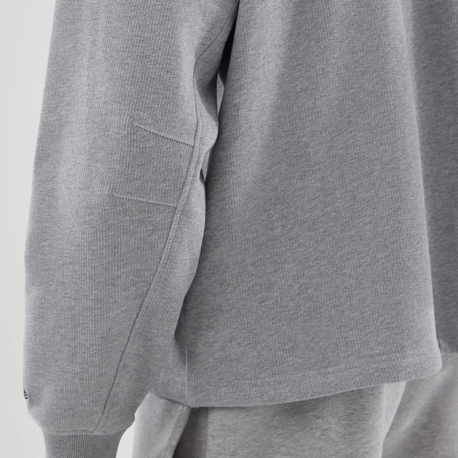The model is wearing this New Era Oversized Crew Neck Sweater in grey. 6