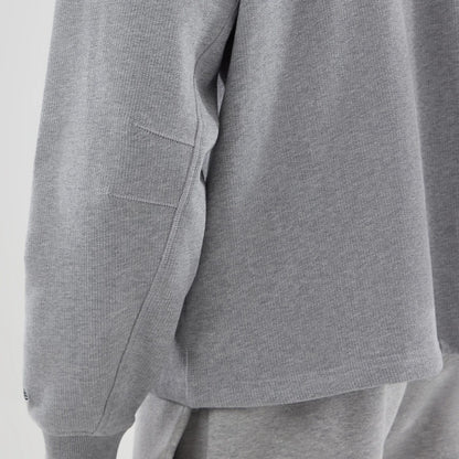 The model is wearing this New Era Oversized Crew Neck Sweater in grey. 6