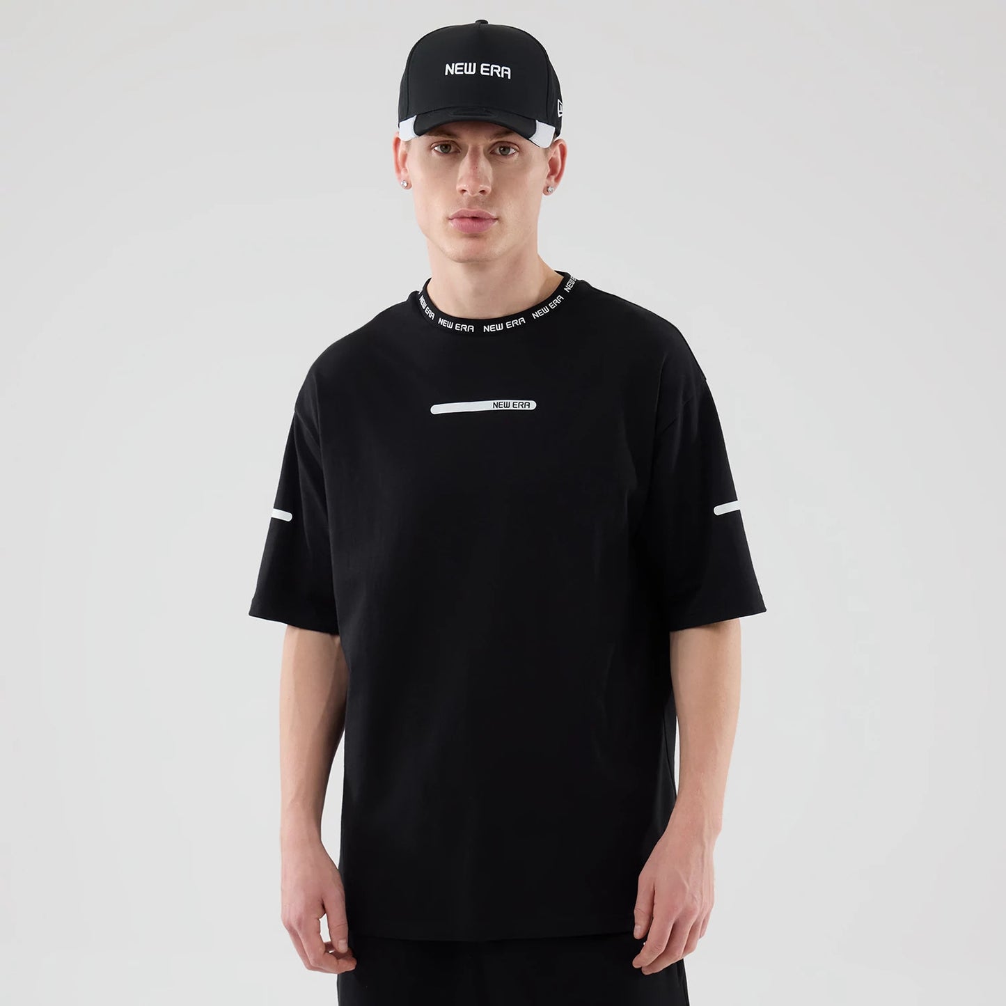 The model is wearing this New Era Tech T-Shirt in black. 1