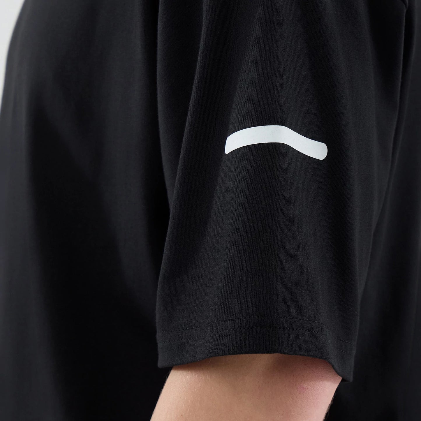The model is wearing this New Era Tech T-Shirt in black. 6
