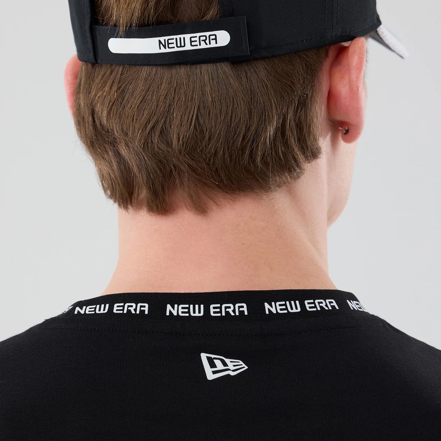 The model is wearing this New Era Tech T-Shirt in black. 7