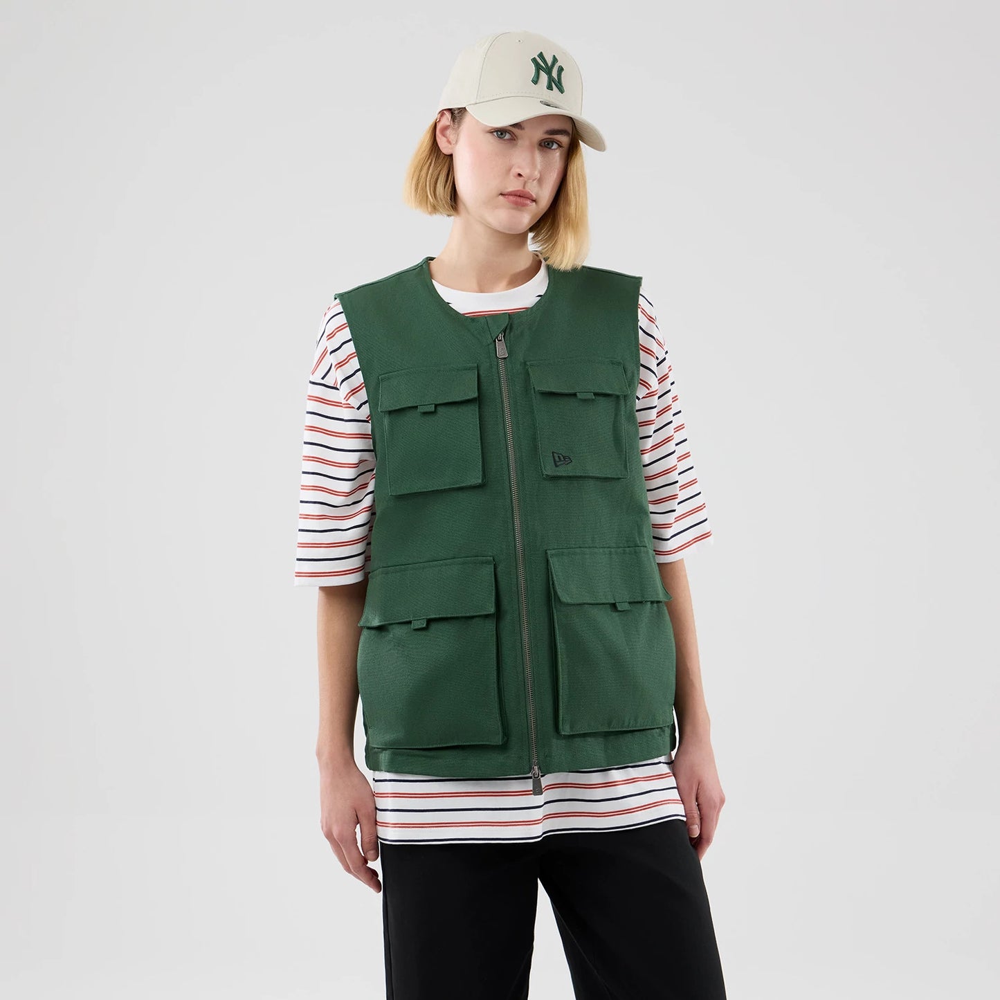 The model is wearing this New Era Utility Vest in dark green. 4