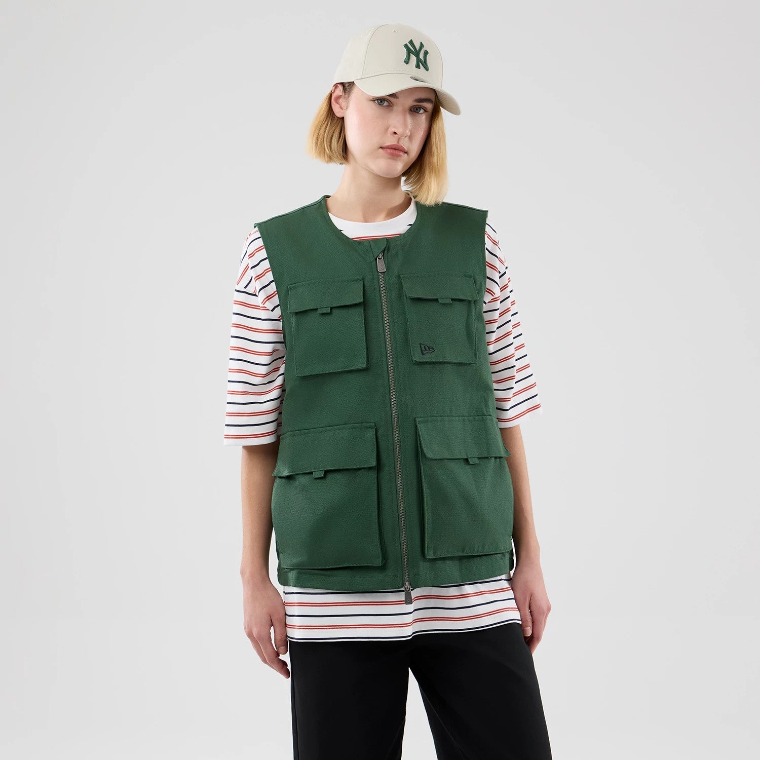 The model is wearing this New Era Utility Vest in dark green. 4