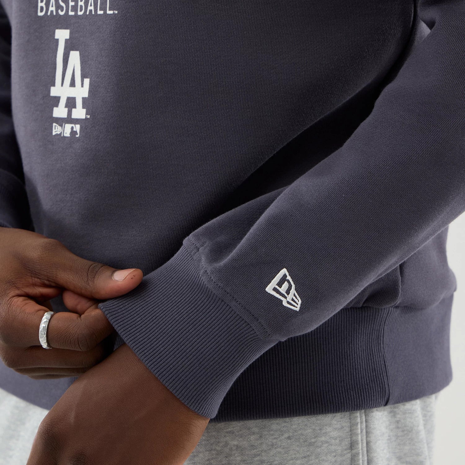 The model is wearing this MLB Graphic LA Dodgers Oversized Crew Neck Sweater in grey. 7